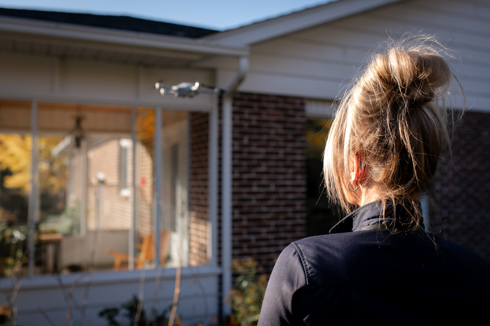Myriam Dion de dos en train d'inspecter une maison