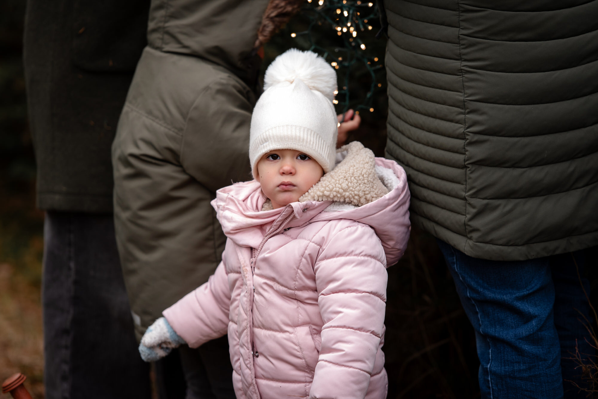 Photo spontanée d'une jeune fille avec manteau rose et tuque blanche à l'extérieur